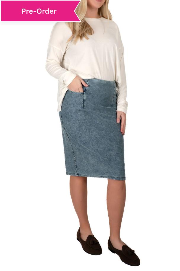 Woman wearing Snoga Athletics modest denim skirt with pockets and a cream long-sleeve top