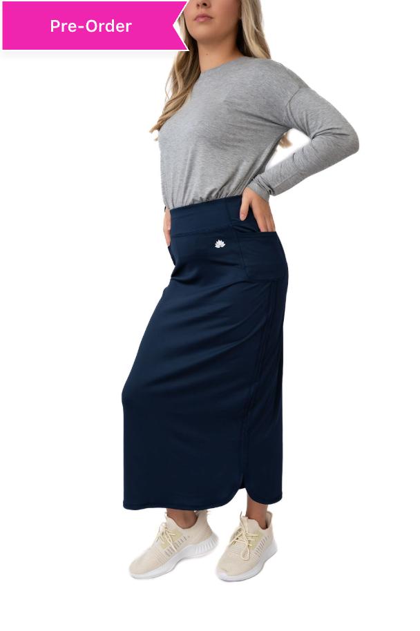 Woman modeling Snoga Athletics modest navy athletic skirt with gray long sleeve top and sneakers