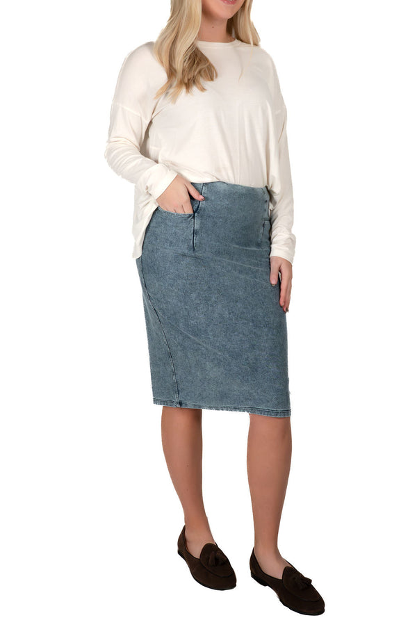 Woman wearing a long sleeve top and modest denim skirt from Snoga Athletics