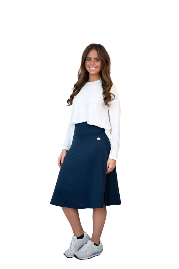Woman wearing Snoga Athletics modest navy skirt and white top activewear