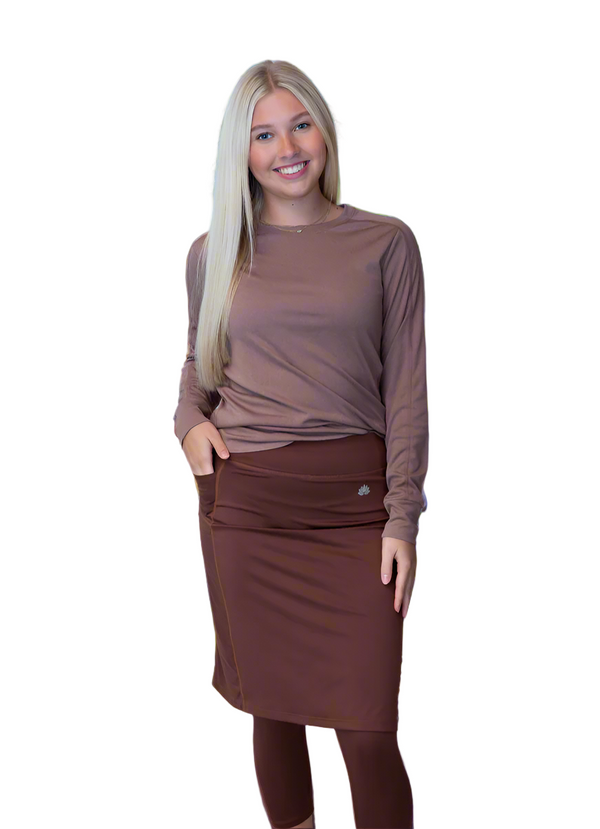 Woman wearing Snoga Athletics brown modest activewear skirt with leggings and long sleeve top