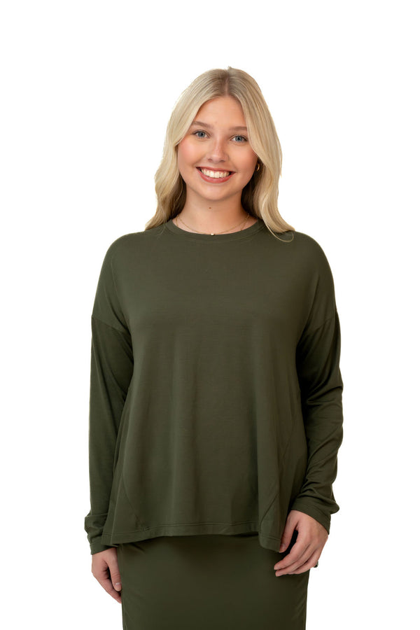 Woman wearing an olive green long sleeve modest top from Snoga Athletics