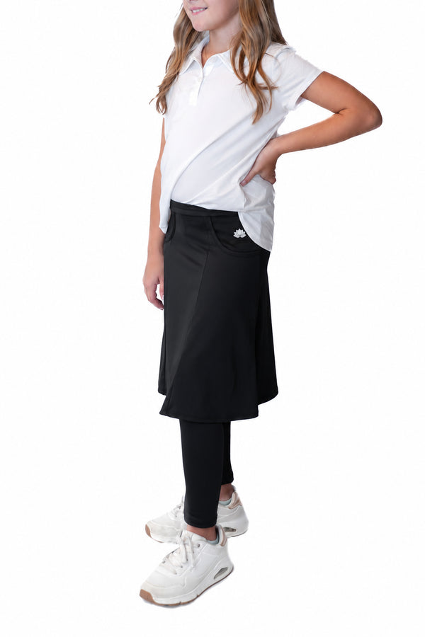 Girl modeling Snoga Athletics black modest skirt with attached leggings and white polo shirt