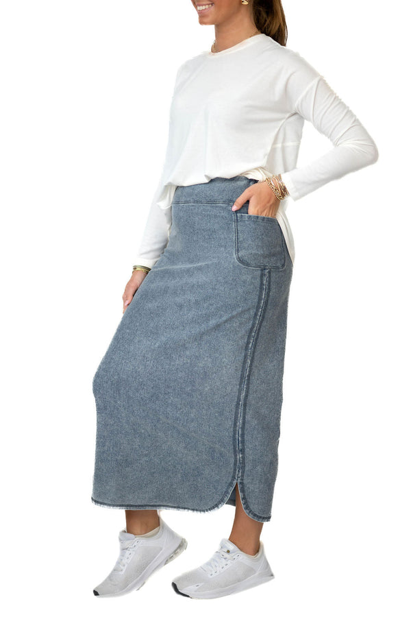 Snoga Athletics model in modest denim ankle-length skirt, white long sleeve top, and sneakers