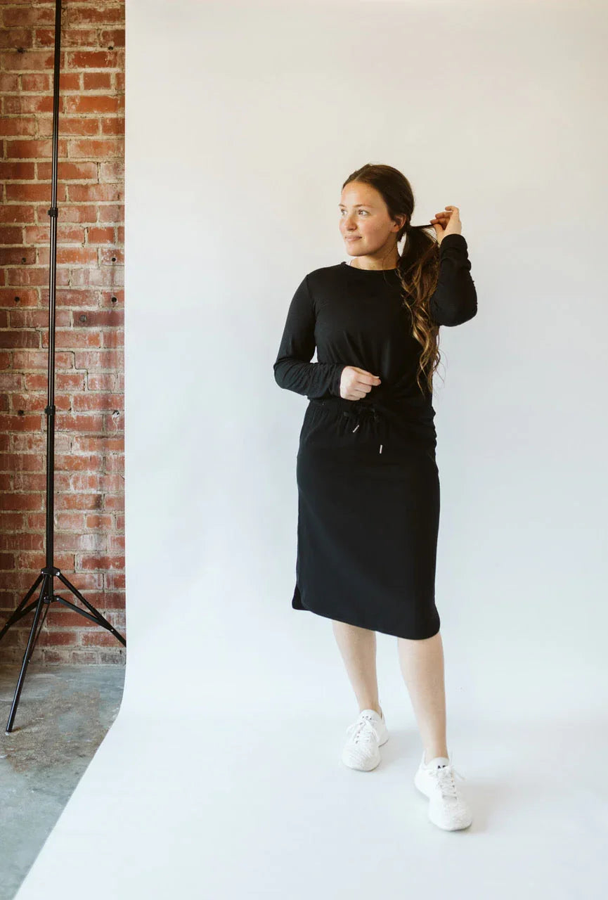 Woman modeling black modest activewear skirt and long sleeve top by Snoga Athletics