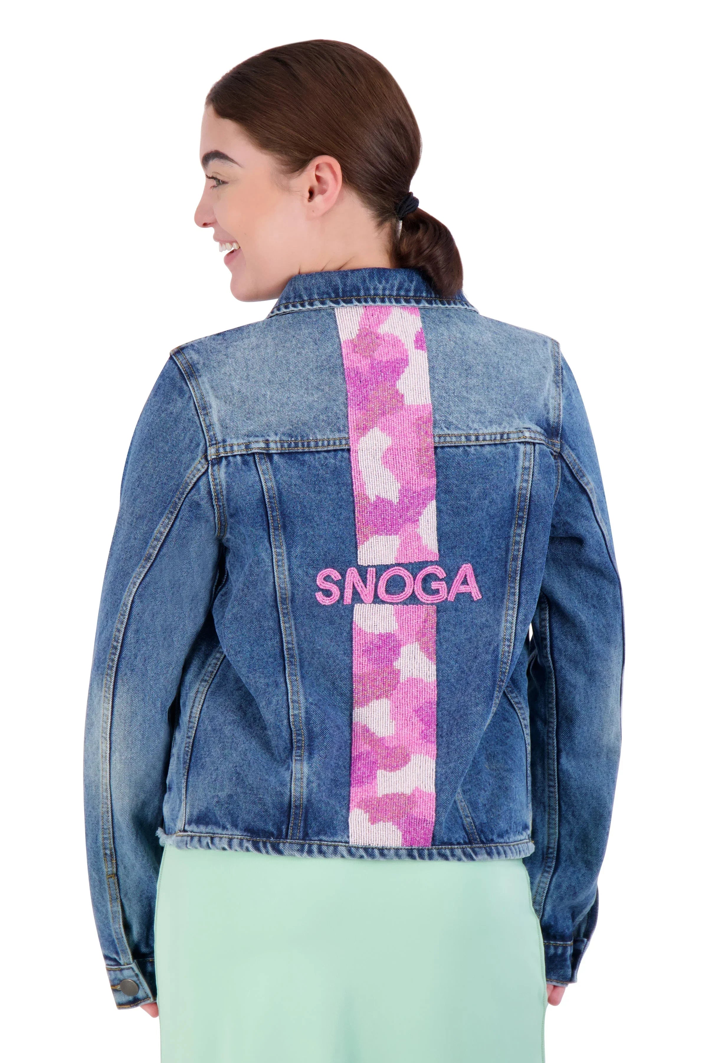 Woman wearing Snoga Athletics denim jacket with pink camo stripe and SNOGA logo on back