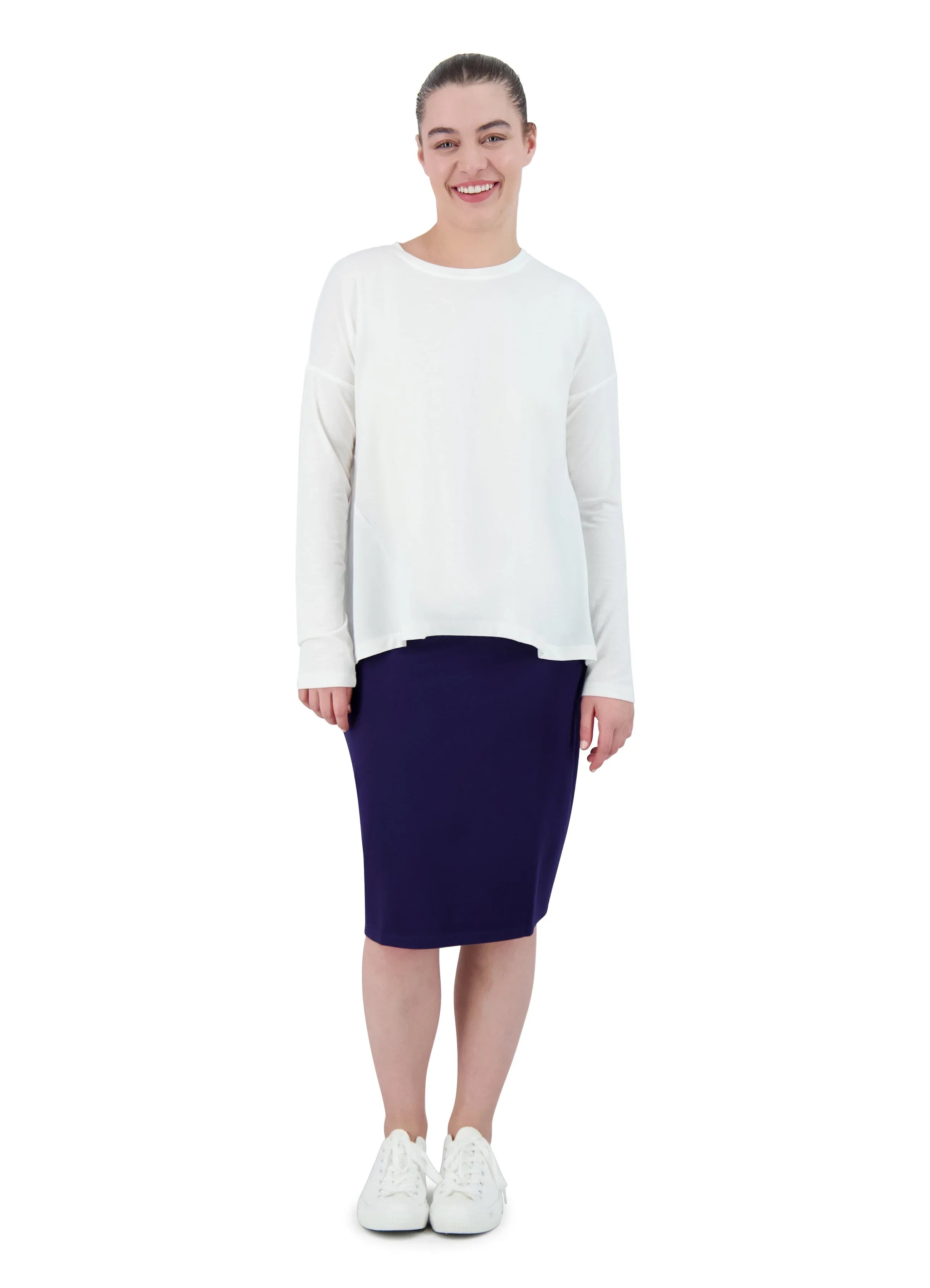 Snoga Athletics ponte knee-length pencil skirt in navy, modeled with white top and sneakers