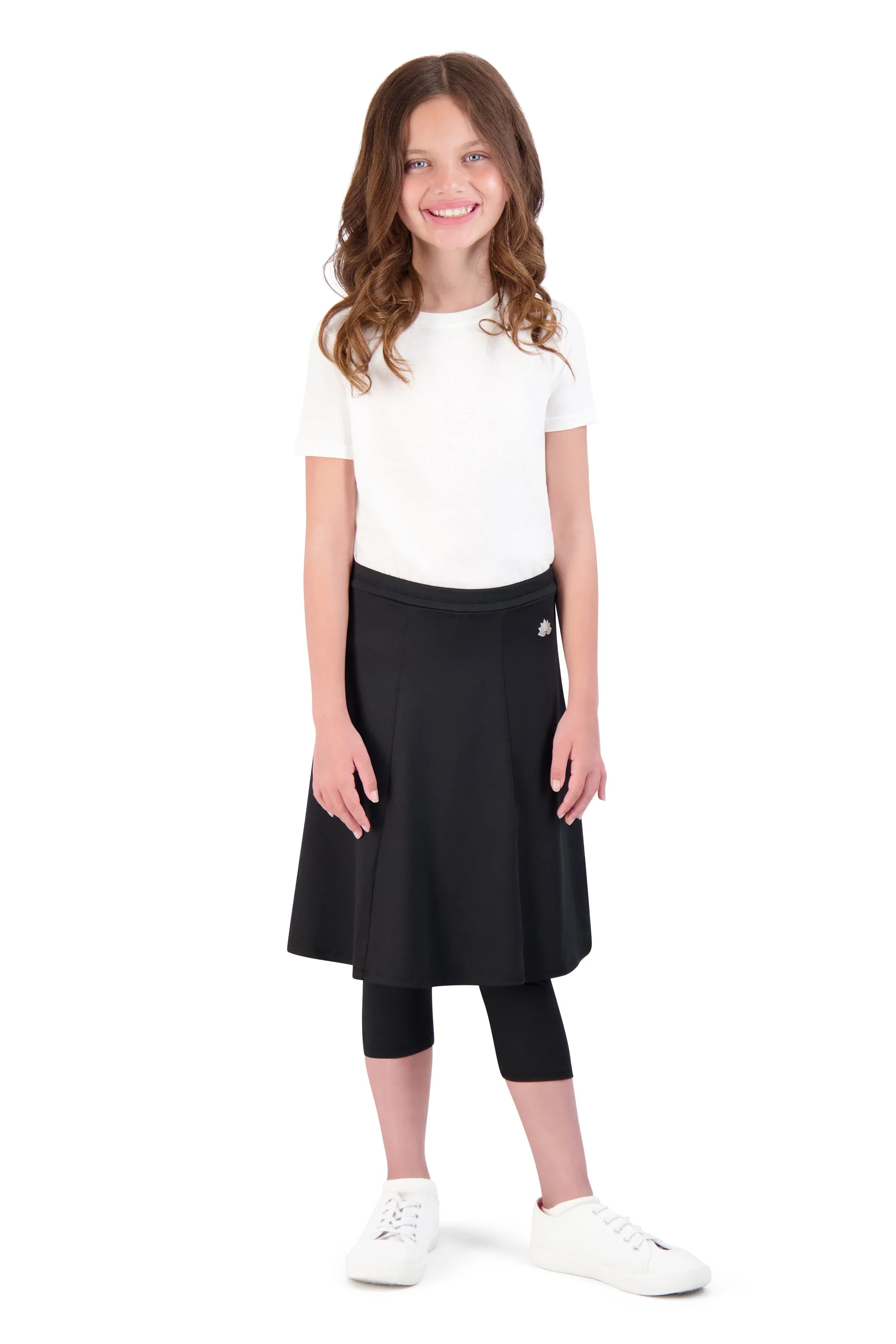 Girl wearing Snoga Athletics black ballet skirt with attached leggings and white shirt