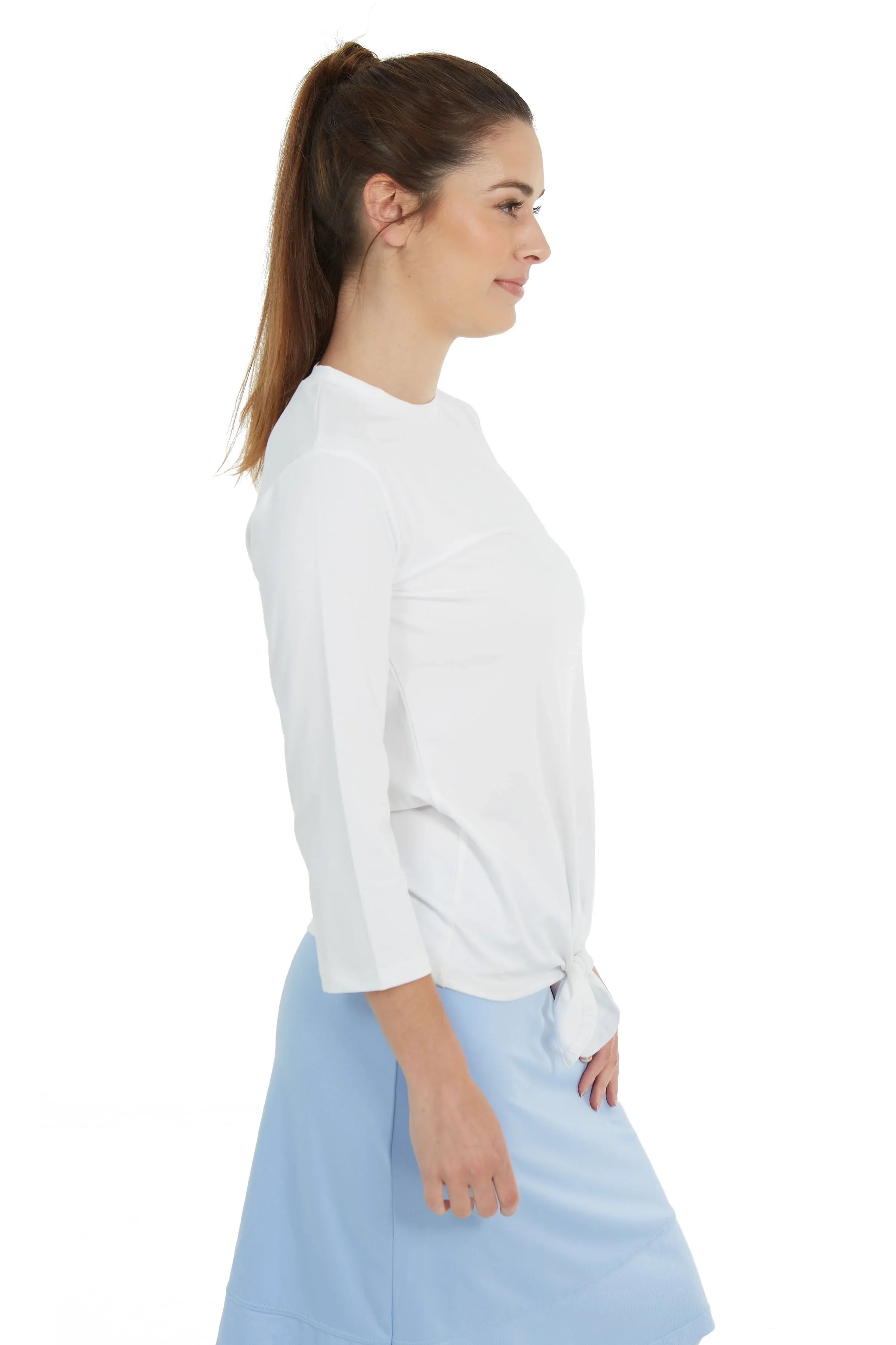 Woman in Snoga Athletics white tie-front active tee and light blue skirt, side view