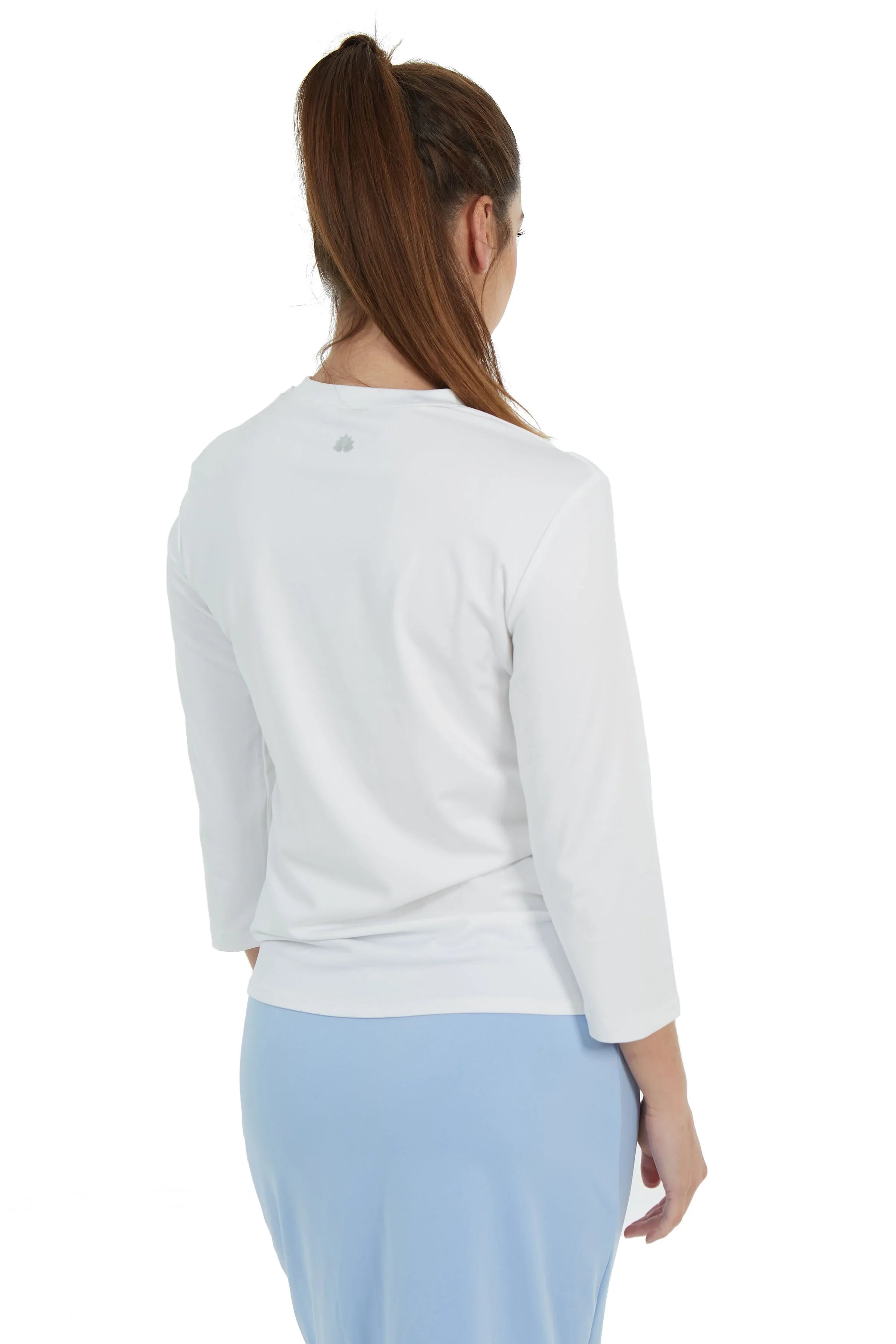 Back view of woman in white Snoga Athletics active tee and light blue skirt