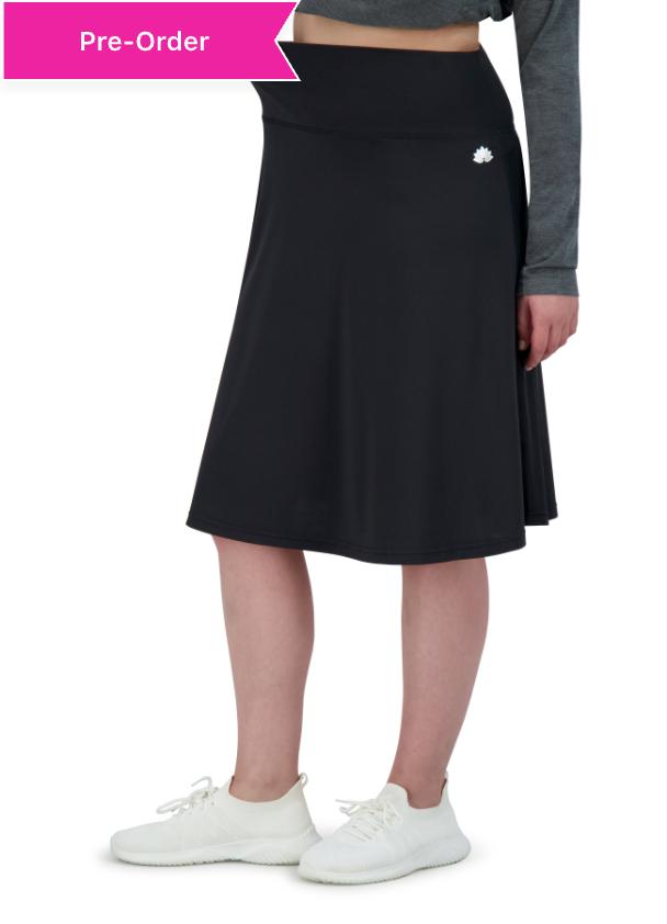 Snoga Athletics black lightweight active skirt with zipper pocket, modeled on white sneakers