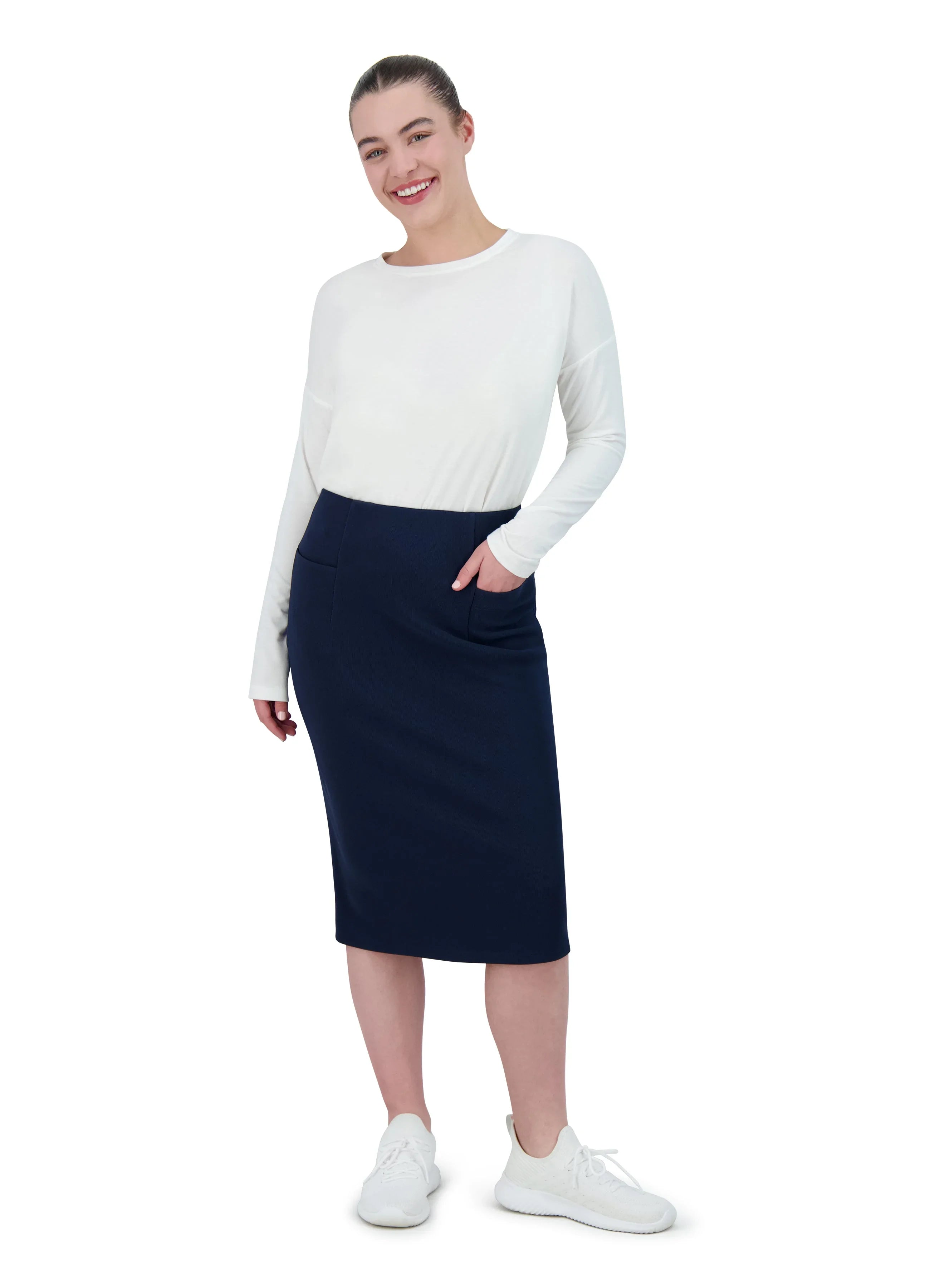 Woman wearing Snoga Athletics navy pencil skirt with front pockets, white long sleeve top, and sneakers