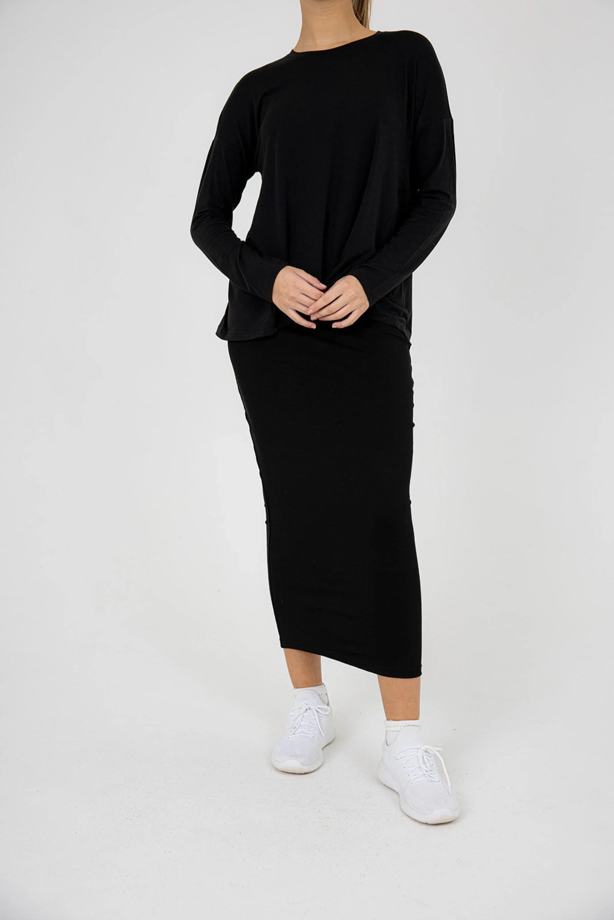 Snoga Athletics black long-sleeve t-shirt and modest skirt activewear outfit