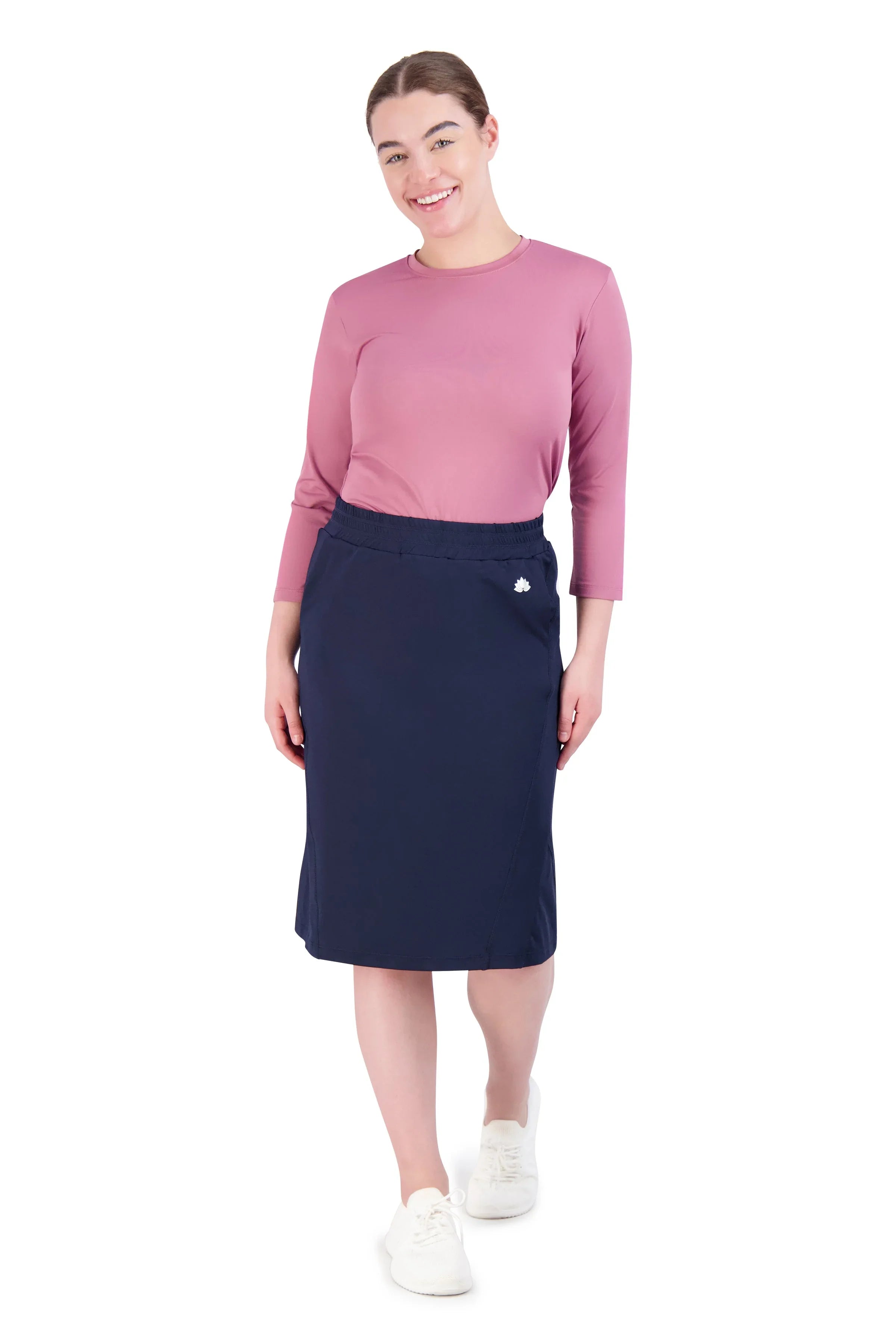 Woman in navy athletic skirt and mauve top by Snoga Athletics, front view on white background