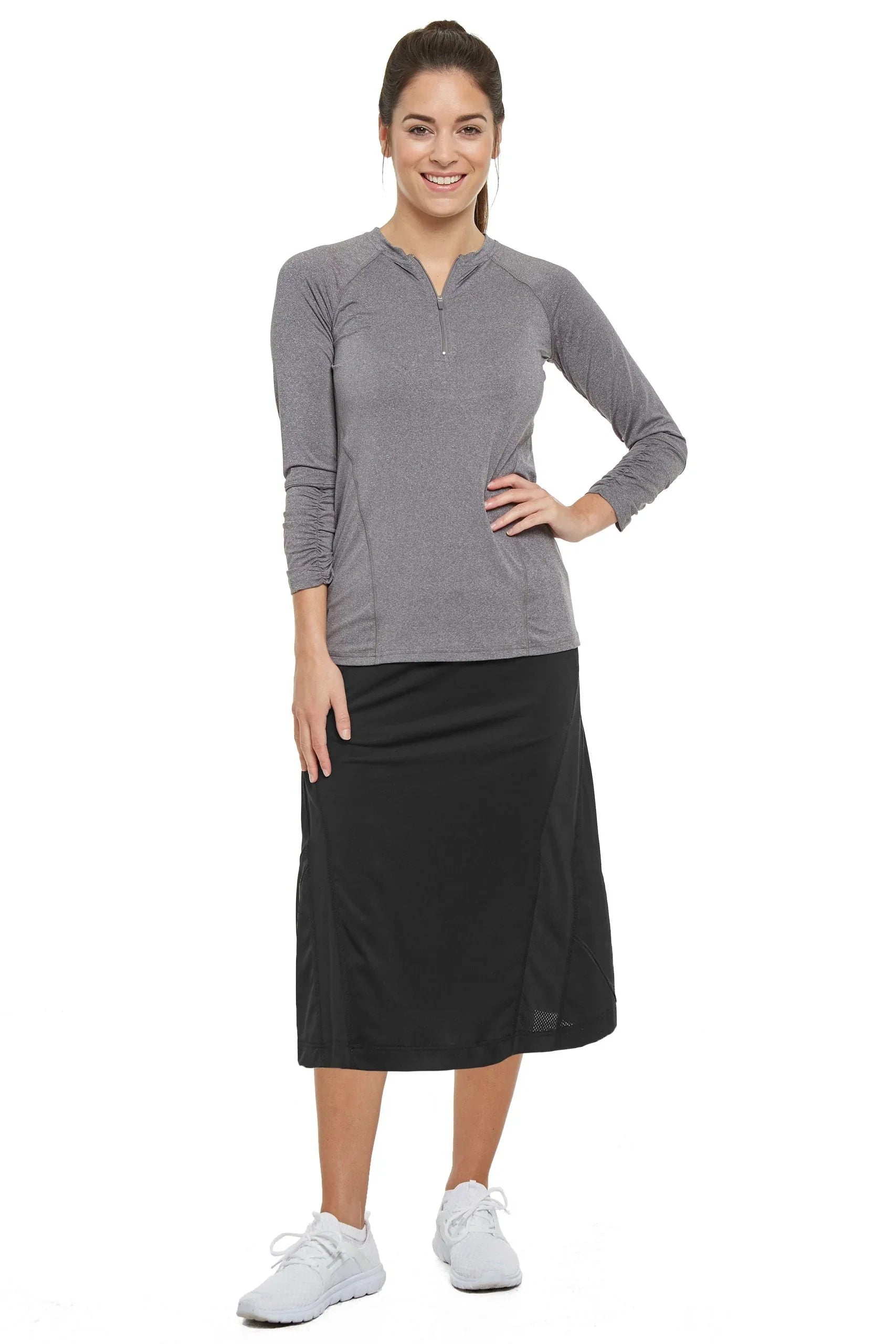 Woman wearing Snoga Athletics black travel skirt with gray long sleeve athletic top