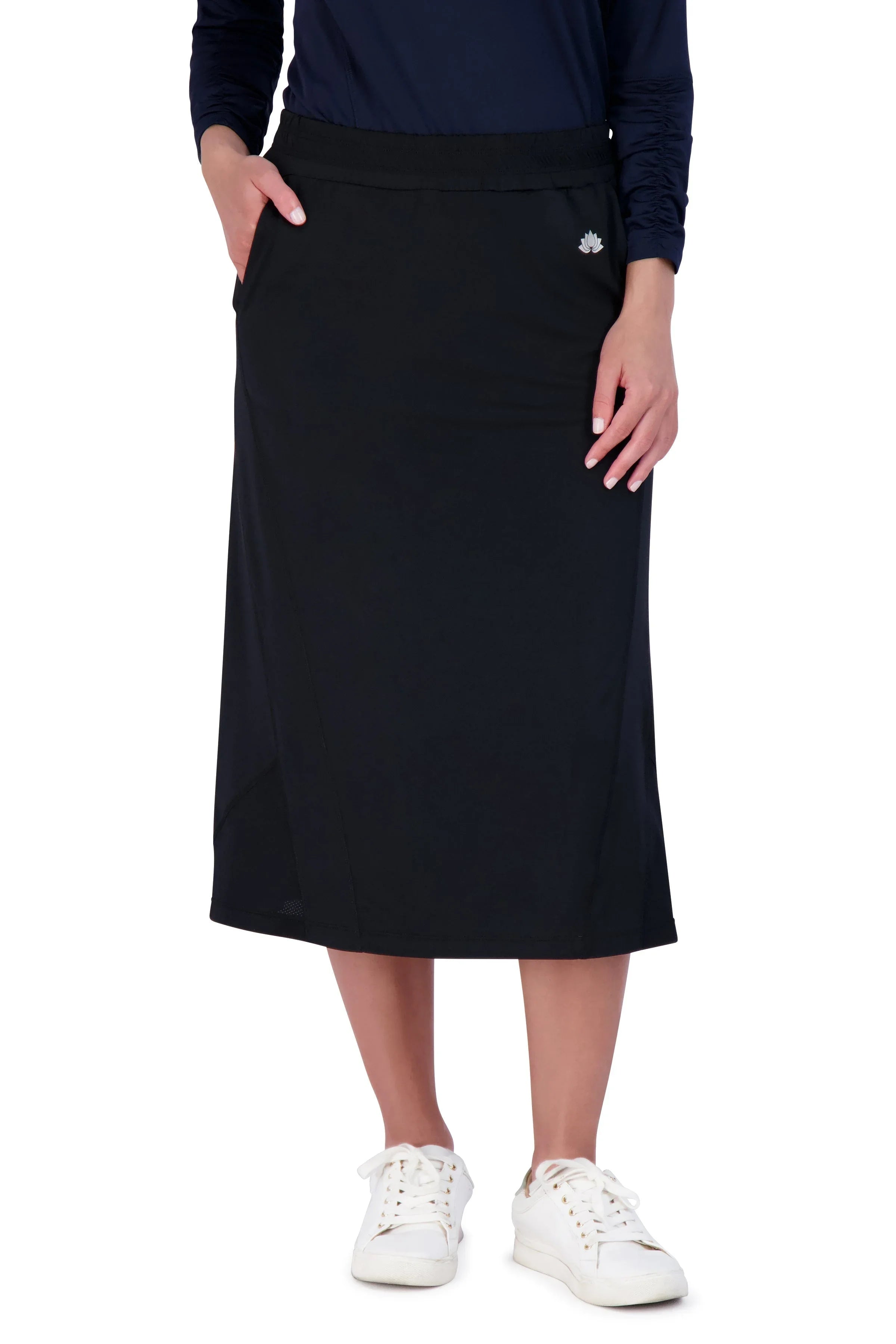 Woman wearing black Snoga Athletics travel skirt with pockets and white sneakers