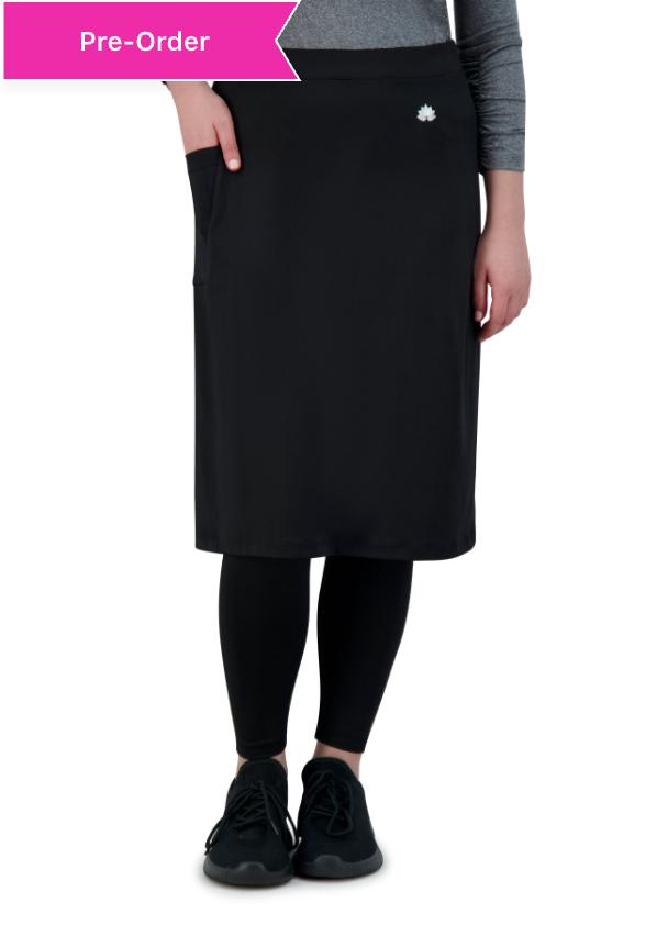 Woman wearing Snoga Athletics black ankle-length skirt with leggings and sneakers.