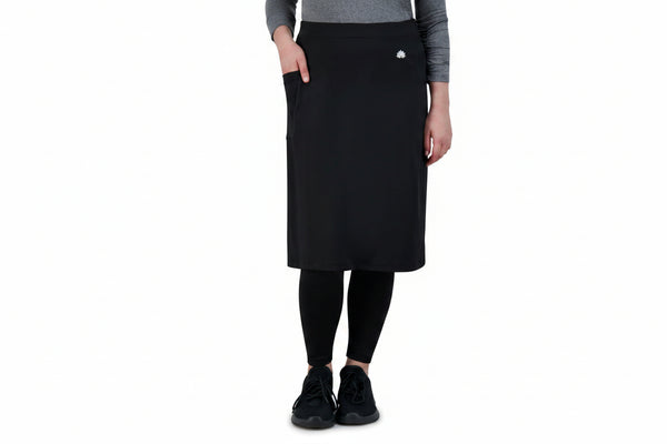 Woman wearing Snoga Athletics black ankle-fit skirt with attached leggings and grey top