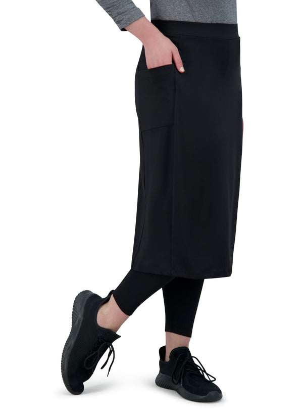 Snoga Athletics black ankle-fit modest skirt with pockets, shown with black leggings and sneakers