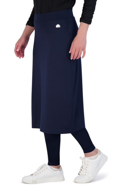Snoga Athletics navy midi skirt with attached leggings, side view, worn with white sneakers