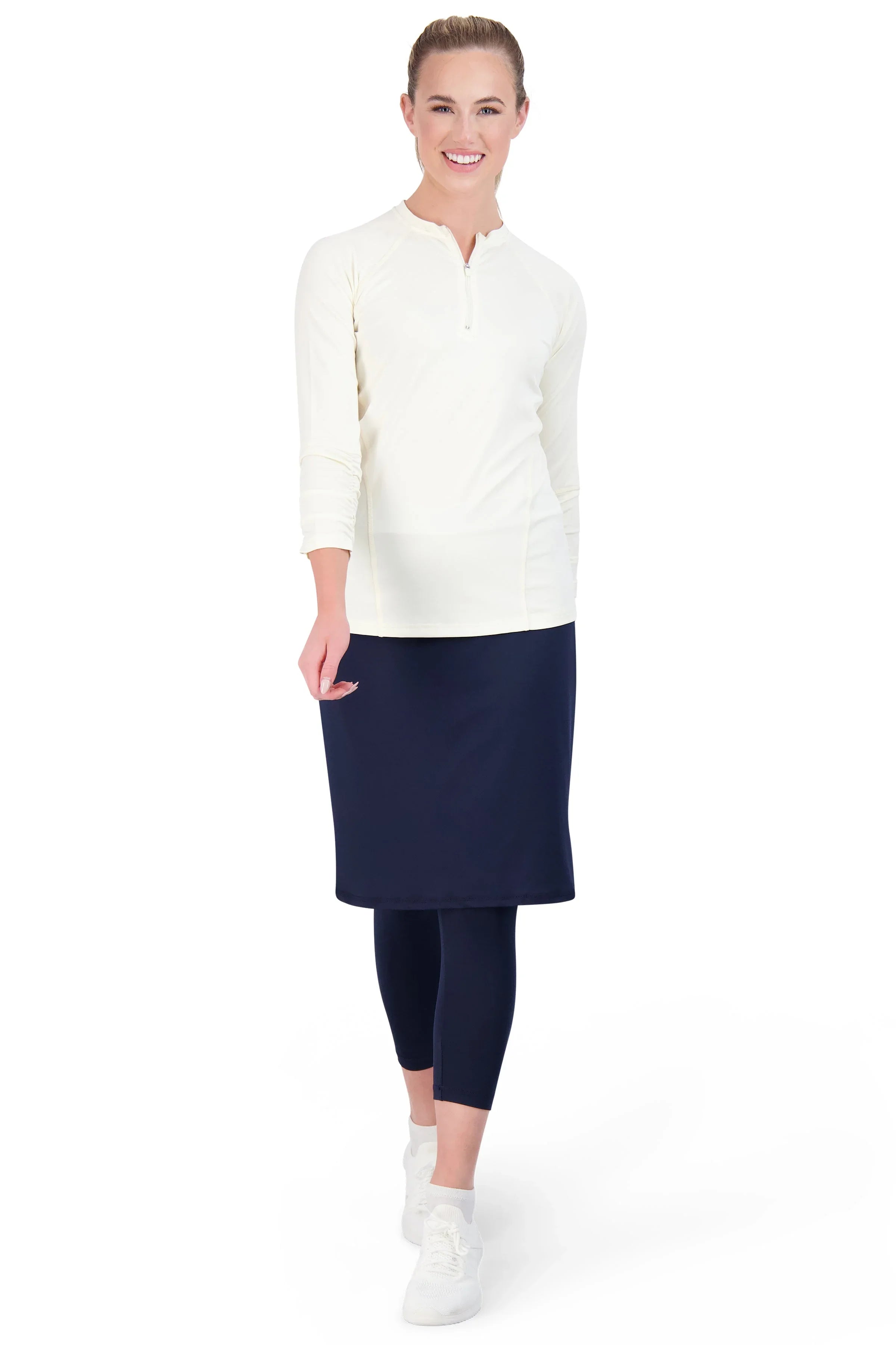 Woman wearing Snoga Athletics navy modest skirted leggings and cream top