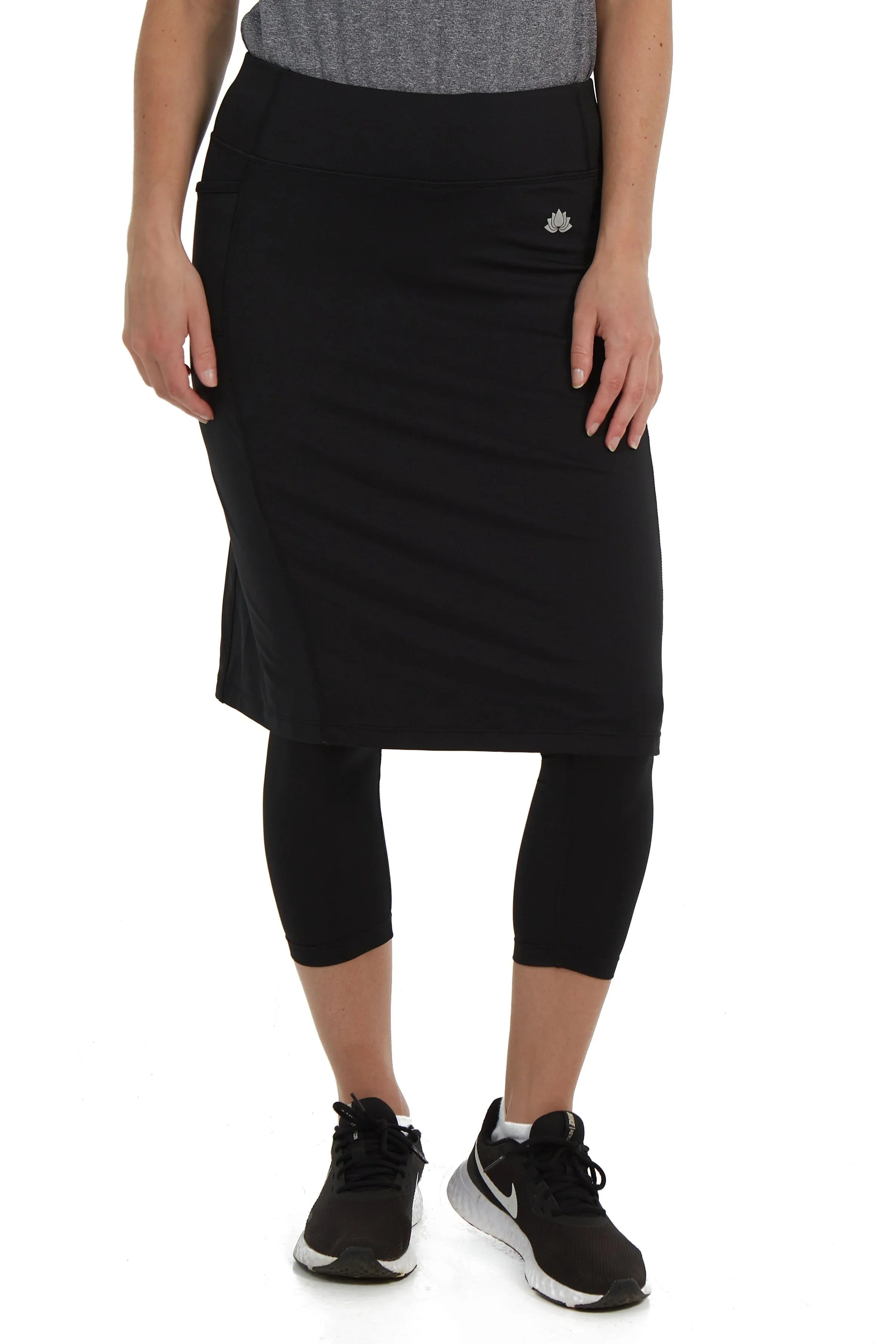 Woman wearing Snoga Athletics black skirted leggings with double pockets, modest activewear