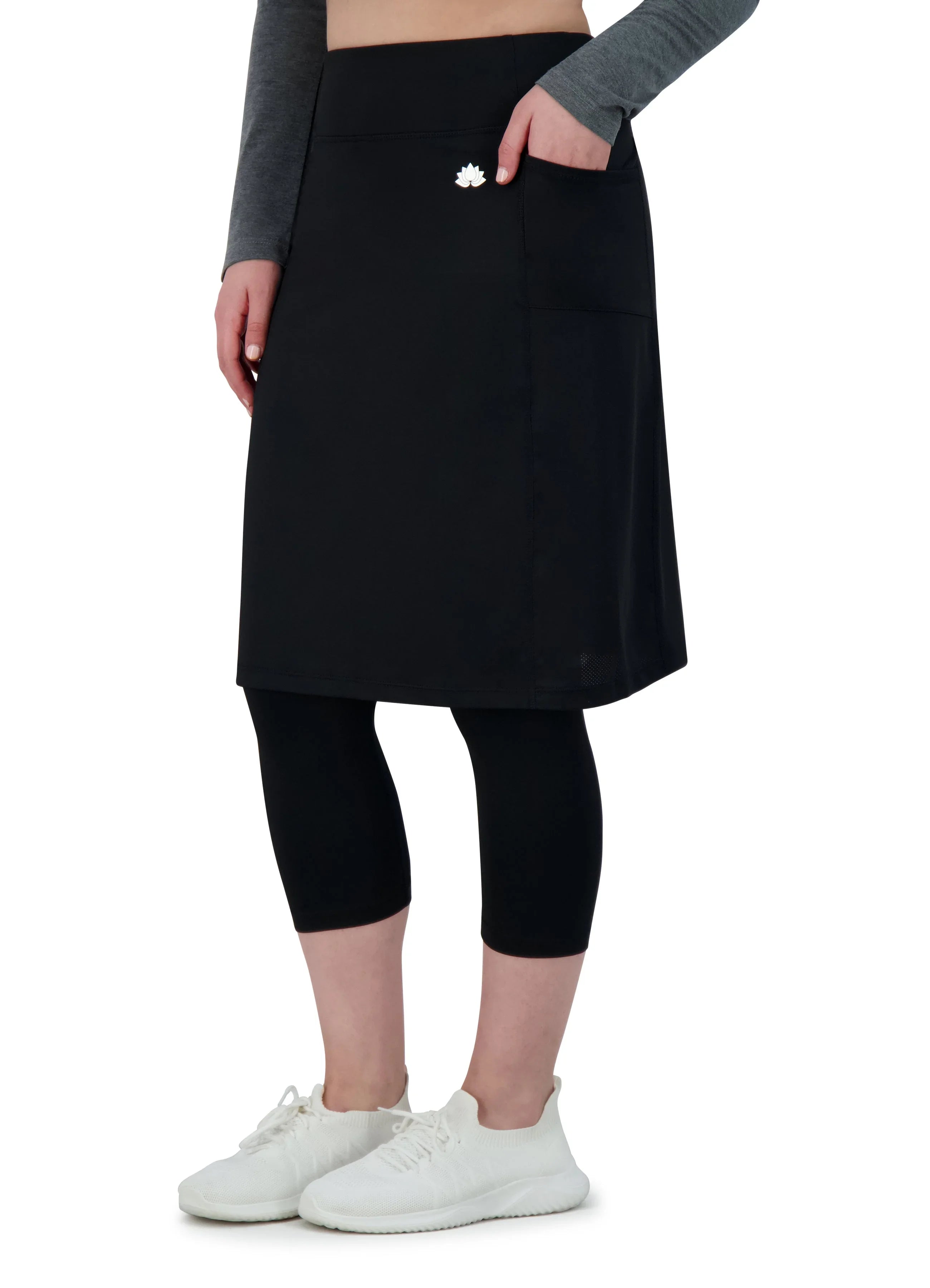 Snoga Athletics black skirted leggings with double pockets, worn with white sneakers