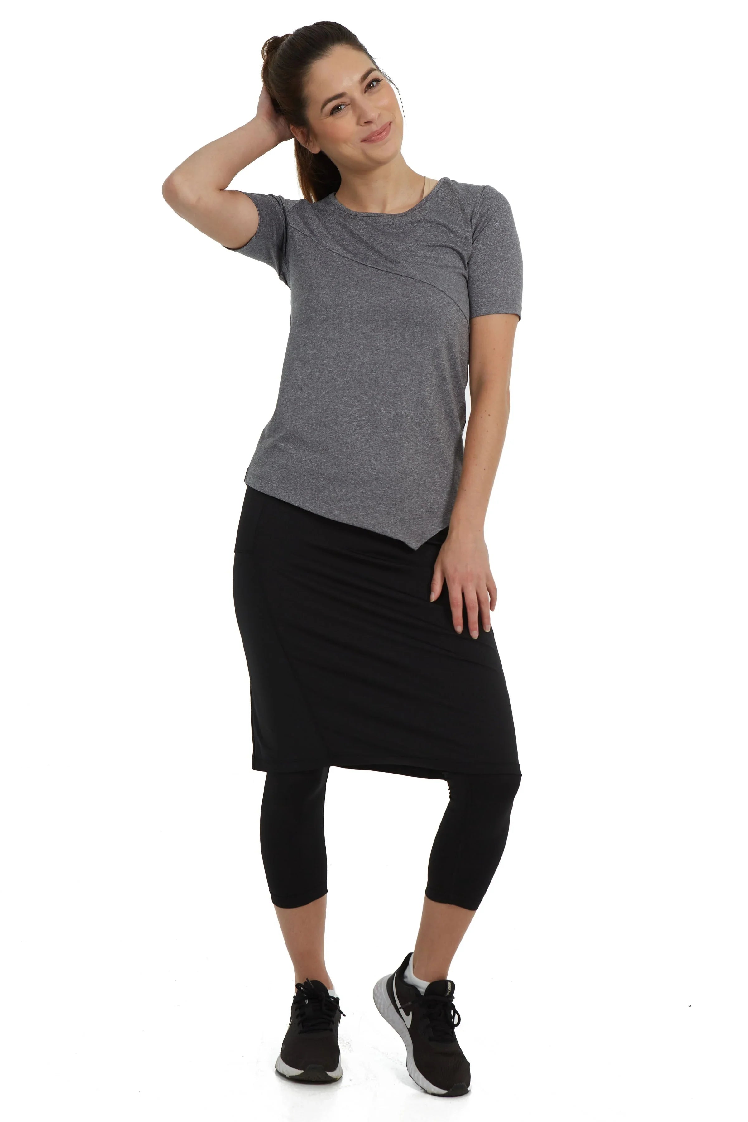 Woman modeling Snoga Athletics double pocket black skirted leggings and grey top