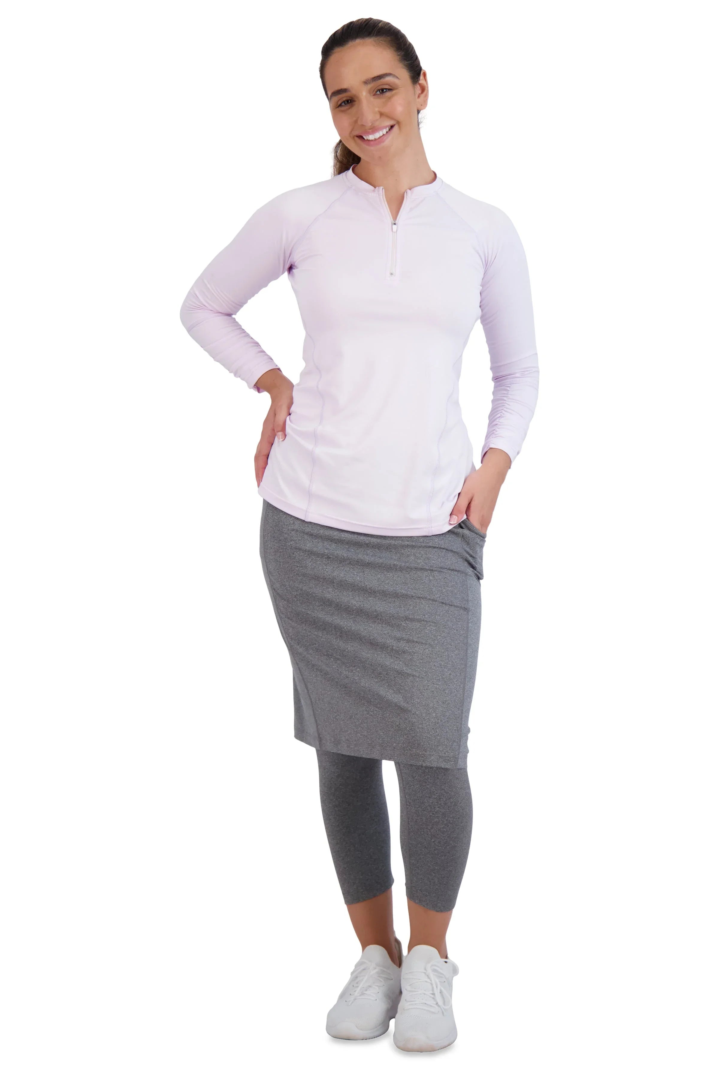 Woman in Snoga Athletics heather grey modest skirted leggings and white top