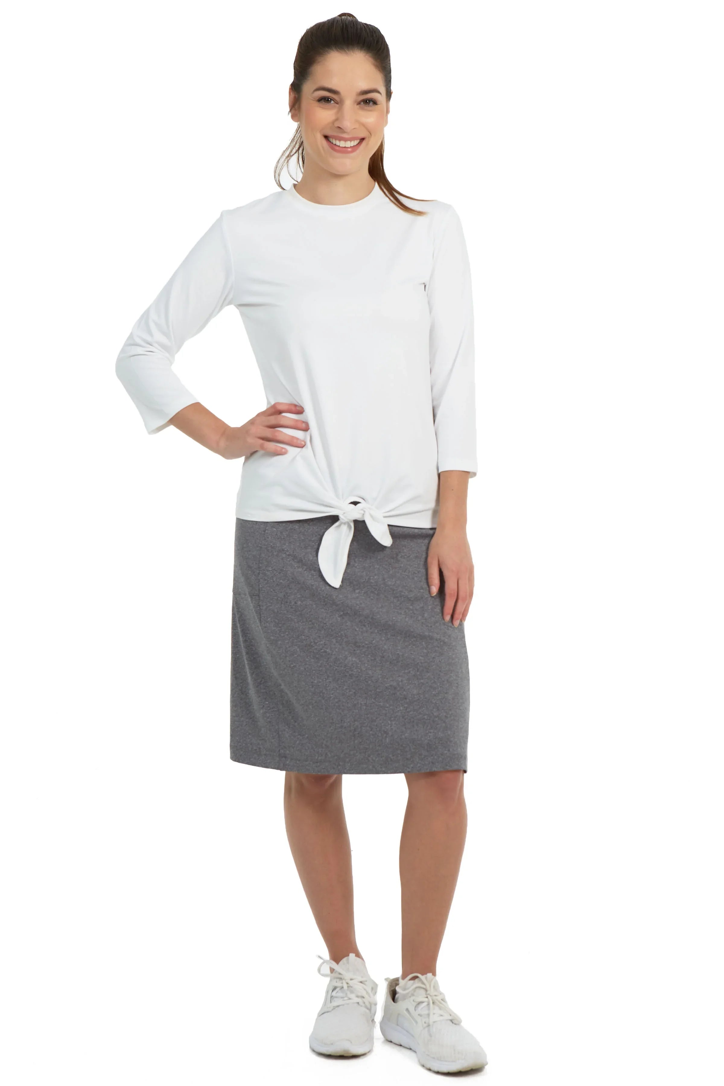 Woman modeling Snoga Athletics heather grey fit skort with white top and sneakers