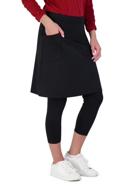 Woman wearing Snoga Athletics black modest skirt with attached leggings and white sneakers