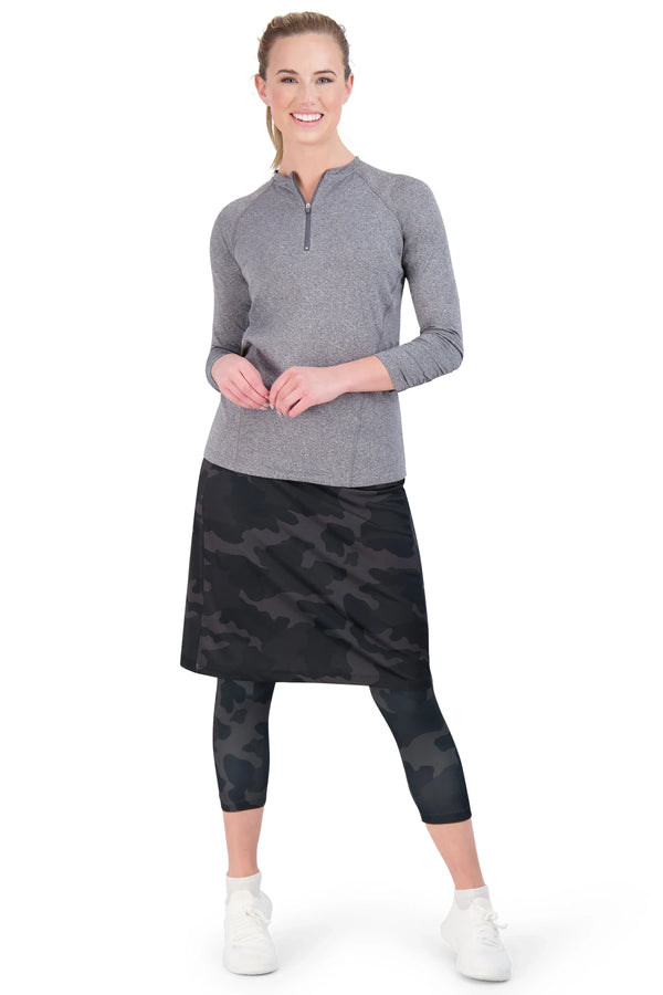 Woman in Snoga Athletics black camo skirted leggings and gray zippered active top