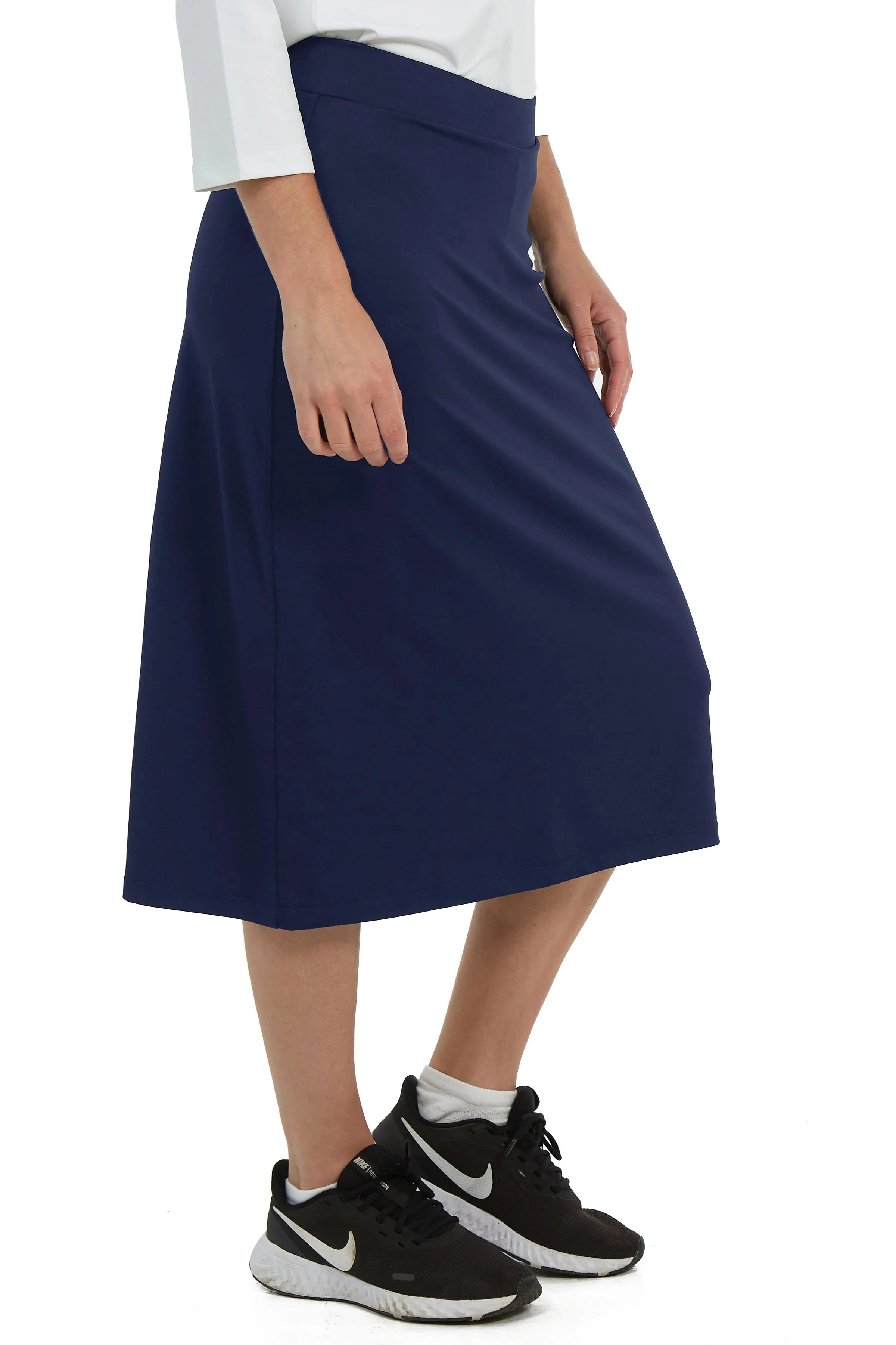 Snoga Athletics navy midi sports skirt with attached shorts, worn by a woman