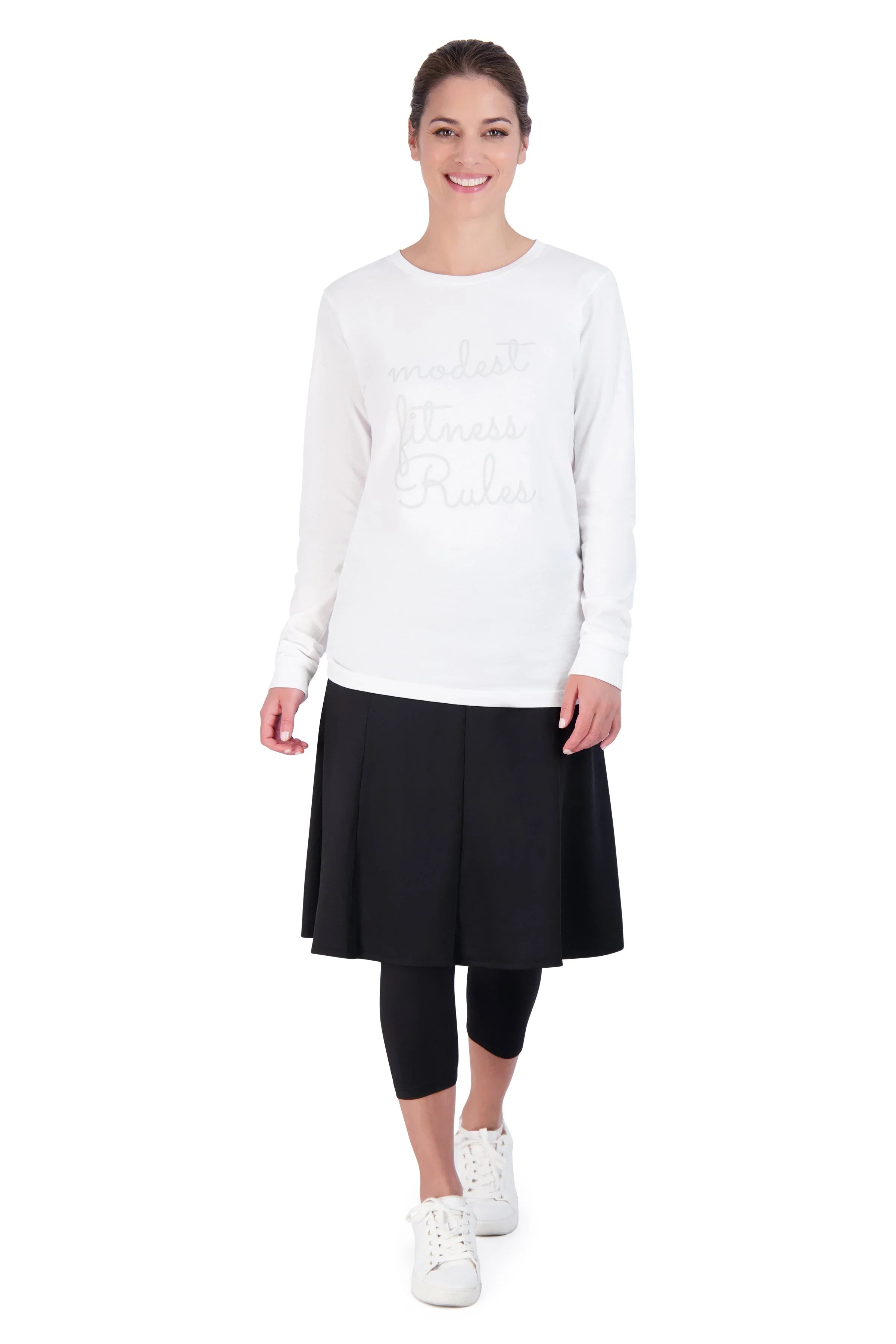 Woman modeling Snoga Athletics modest black skirted leggings and white long sleeve top