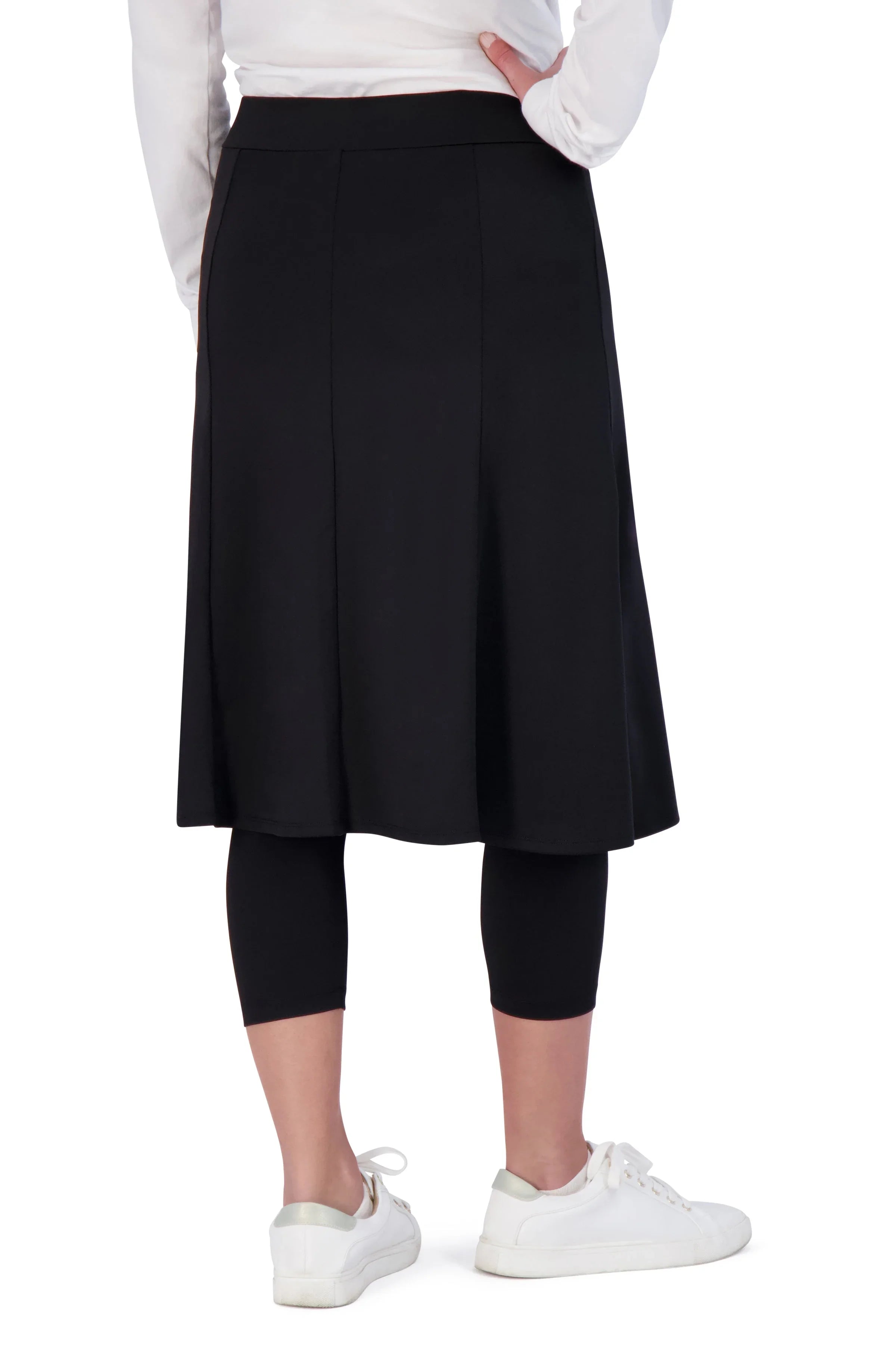 Snoga Athletics black modest skirt with attached capri leggings, worn with white sneakers