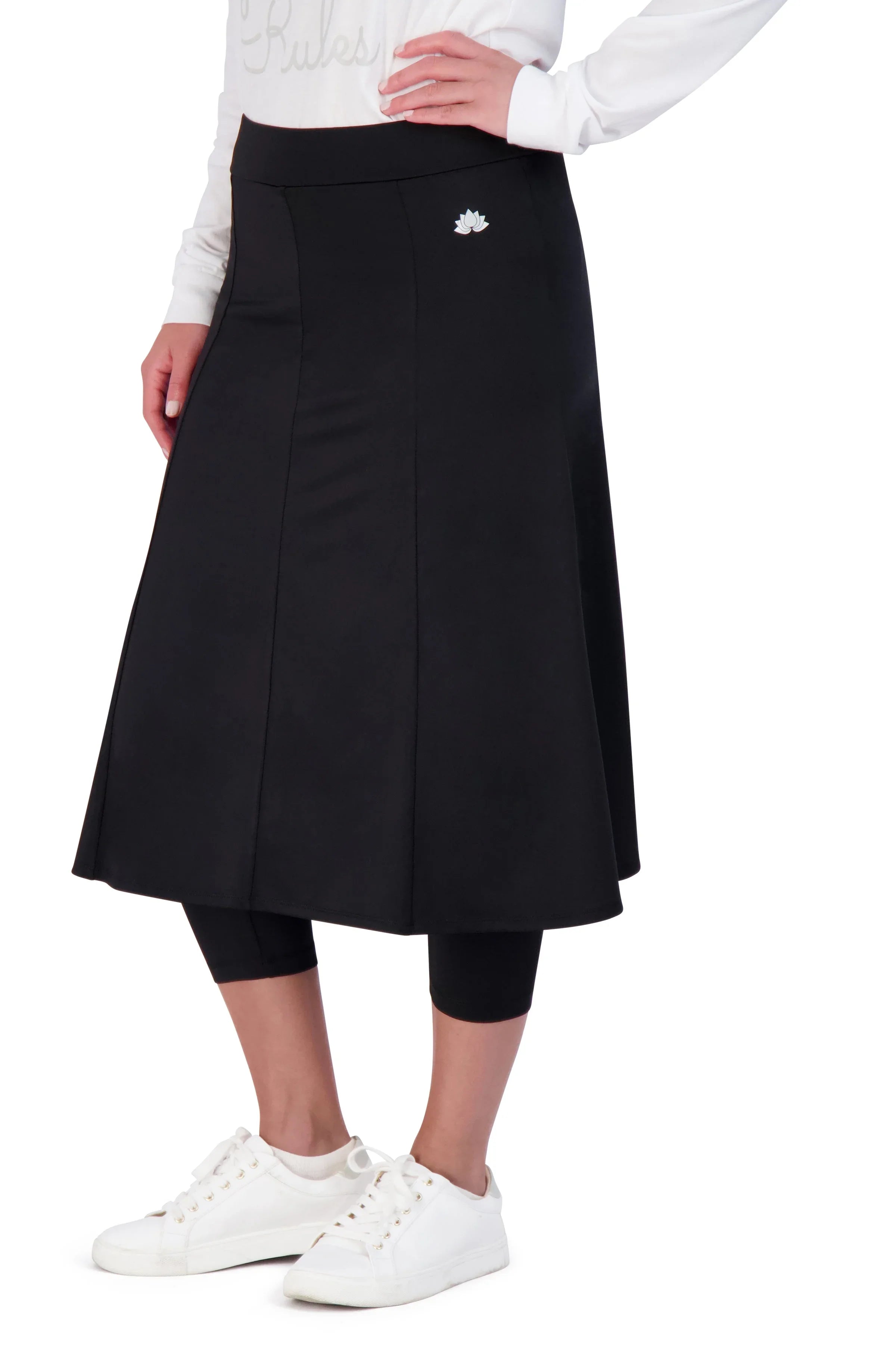 Snoga Athletics black ballet skirt with attached leggings, lotus logo, worn with white sneakers