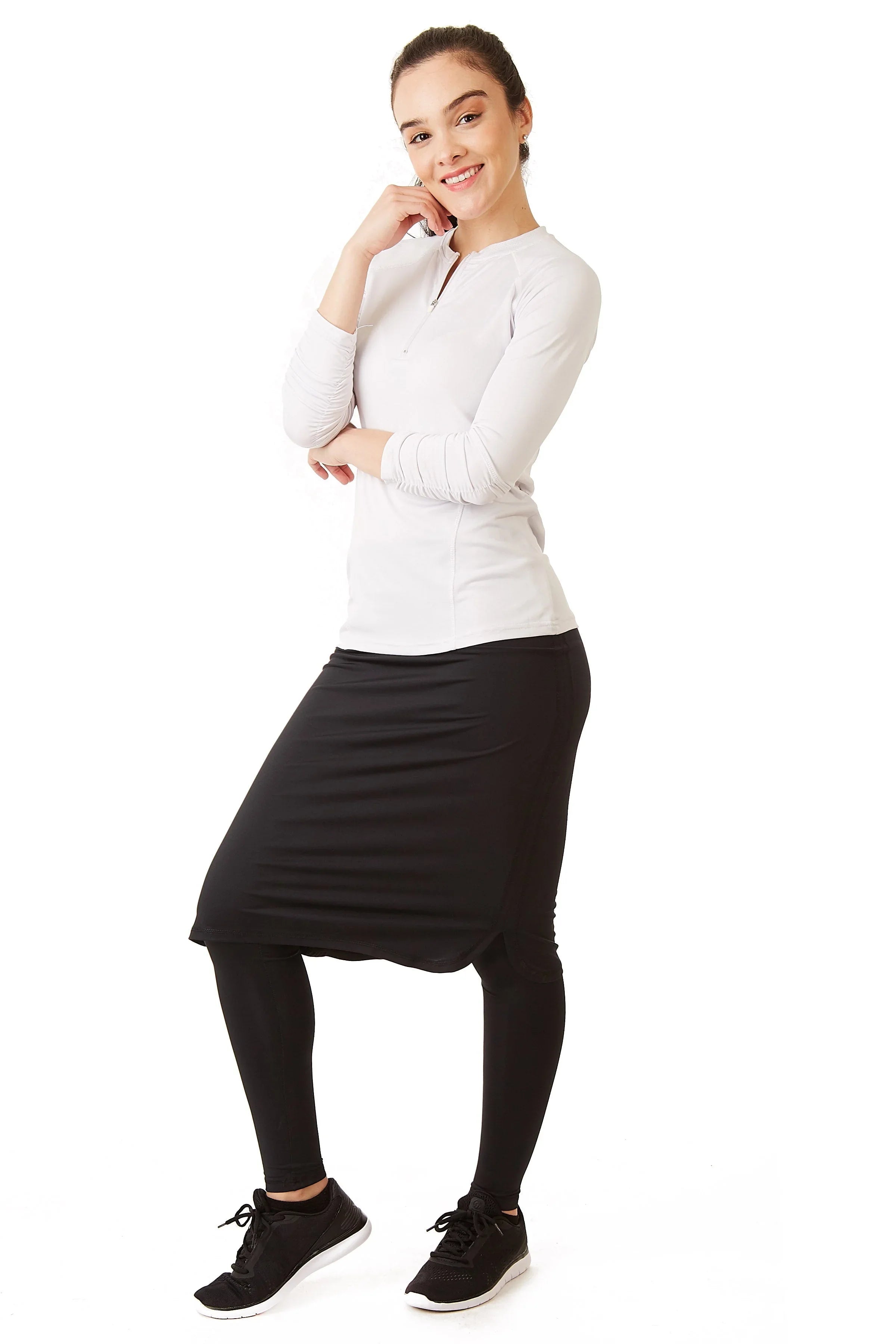 Woman modeling Snoga Athletics black long shirt-tail skirt with leggings, athletic wear
