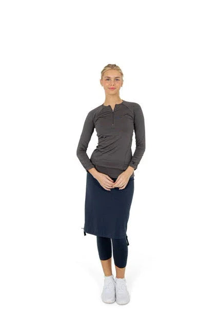 Woman in Snoga Athletics modest activewear skirt with side tie over black leggings, gray top