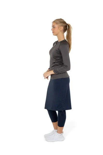 Woman wearing Snoga Athletics modest activewear skirt with attached leggings, side view