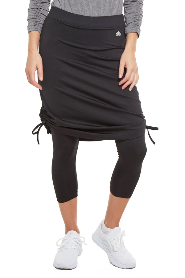 Woman wearing Snoga Athletics black tie-side modest skirt leggings and grey zip top