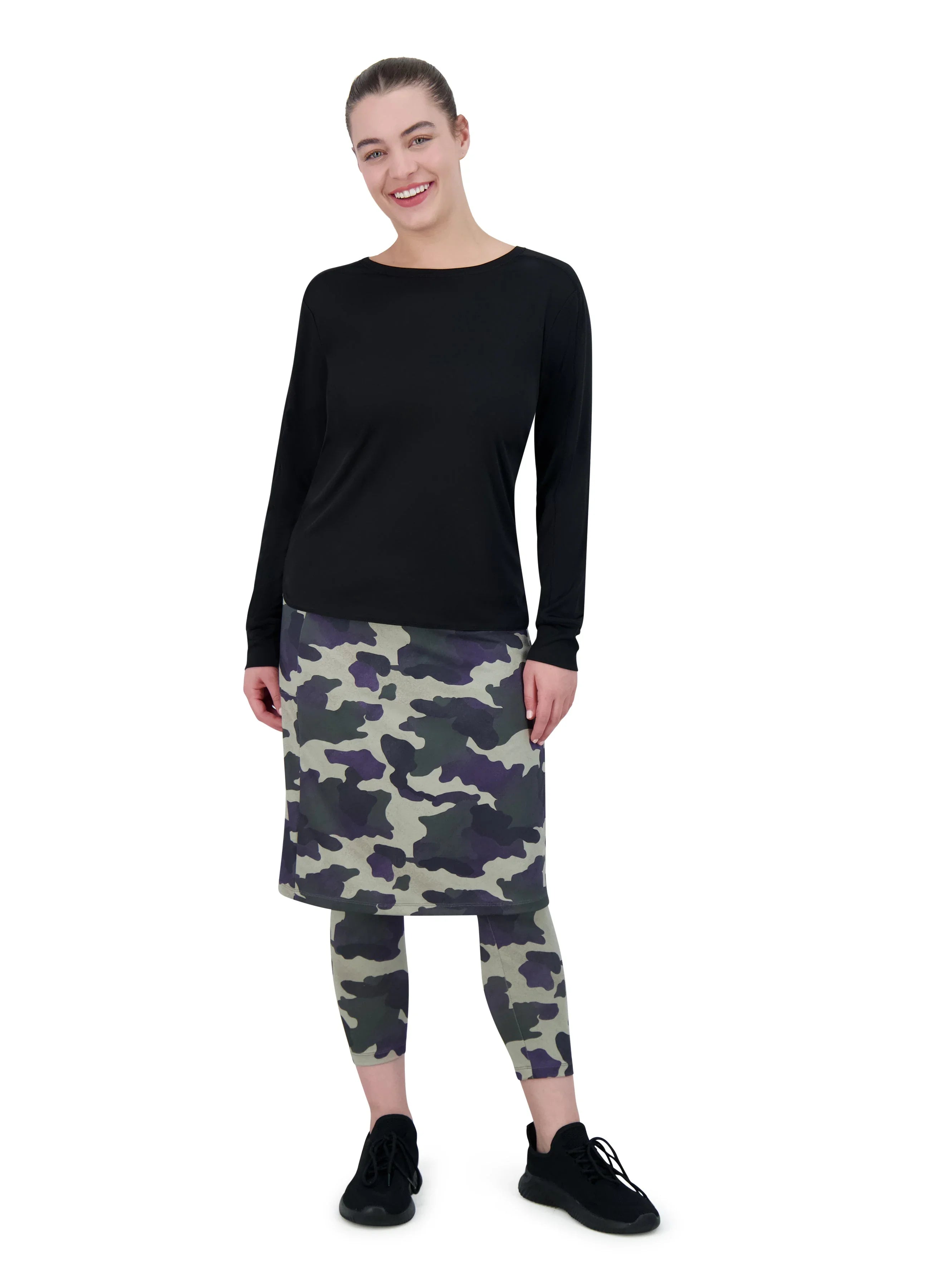 Woman wearing Snoga Athletics black long sleeve active top with camo print skirted leggings