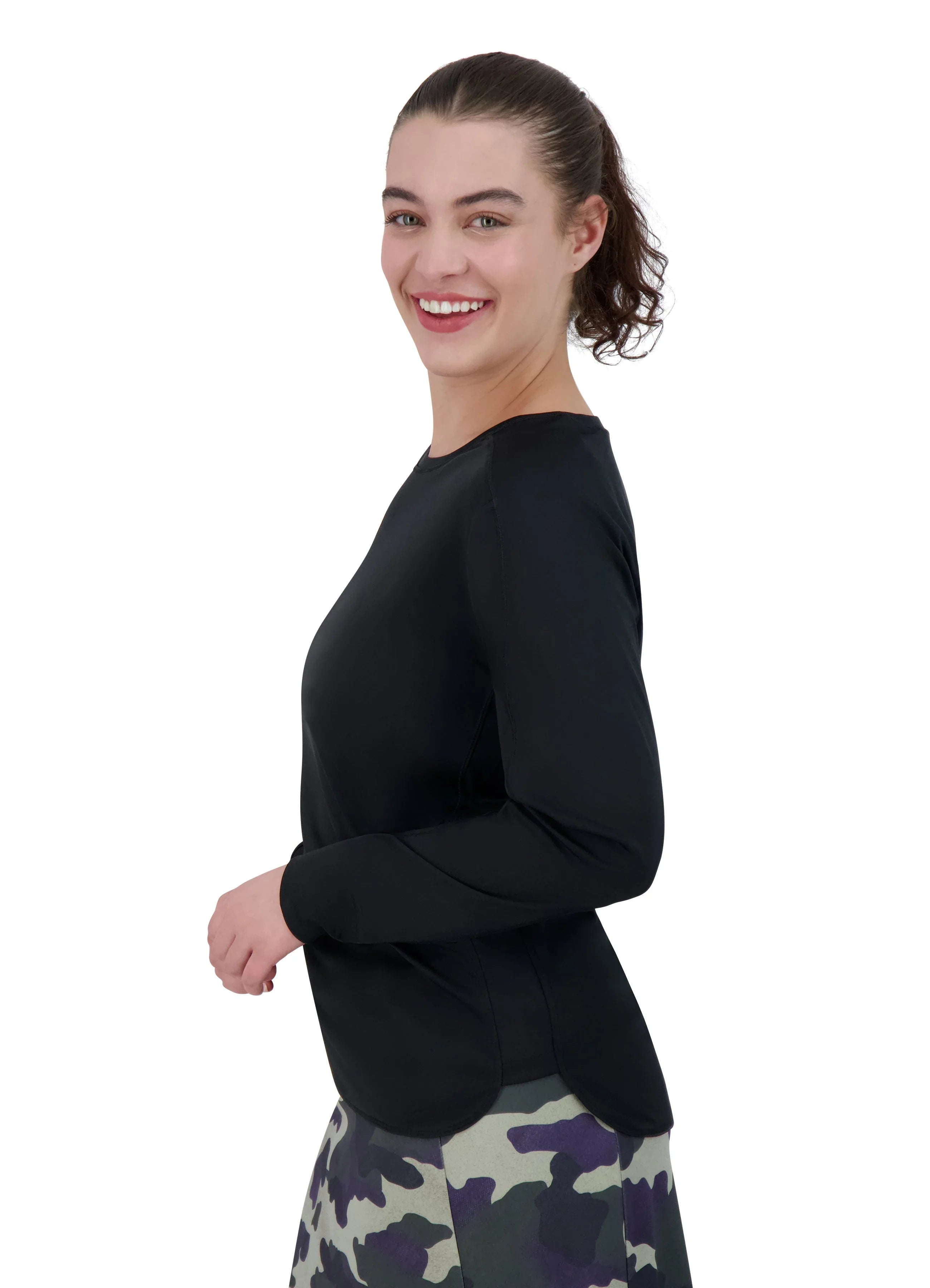 Woman in black relaxed fit long sleeve active top by Snoga Athletics, side view