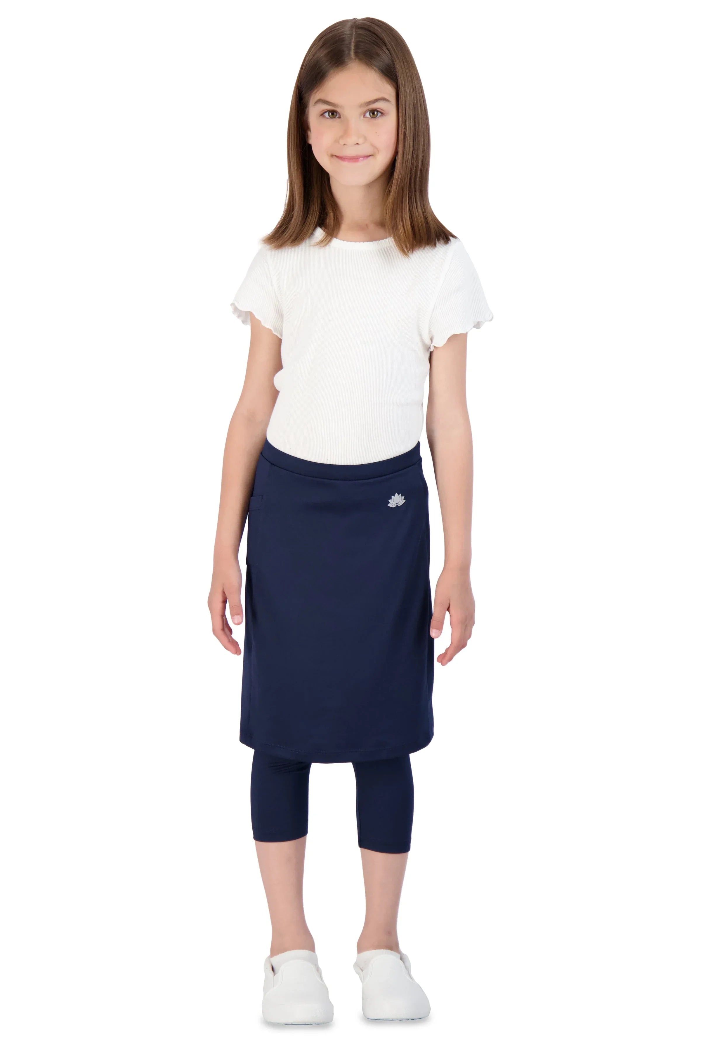 Girl wearing Snoga Athletics navy skirted leggings with white top and shoes