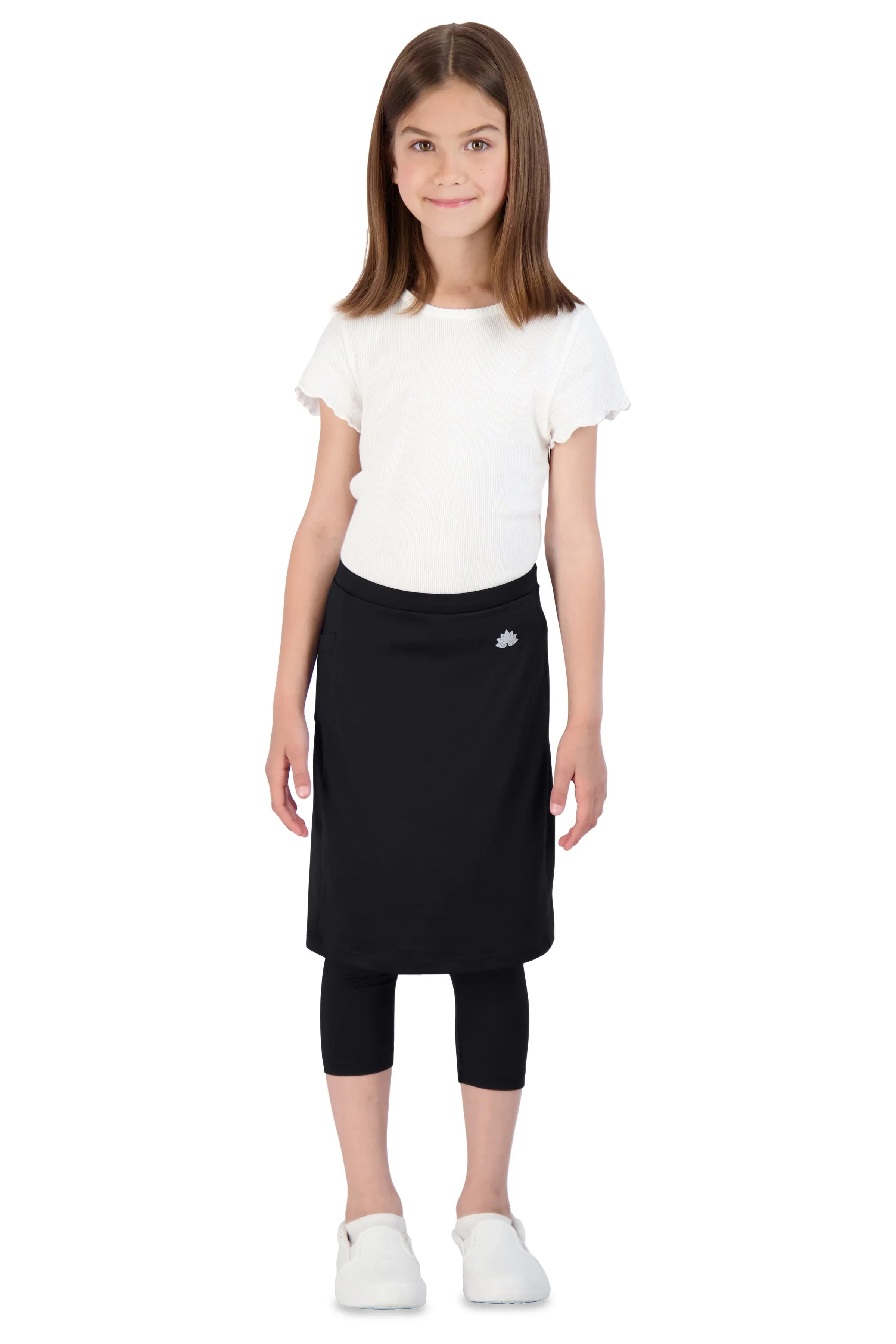 Girl wearing Snoga Athletics black skirted leggings and white top against white background