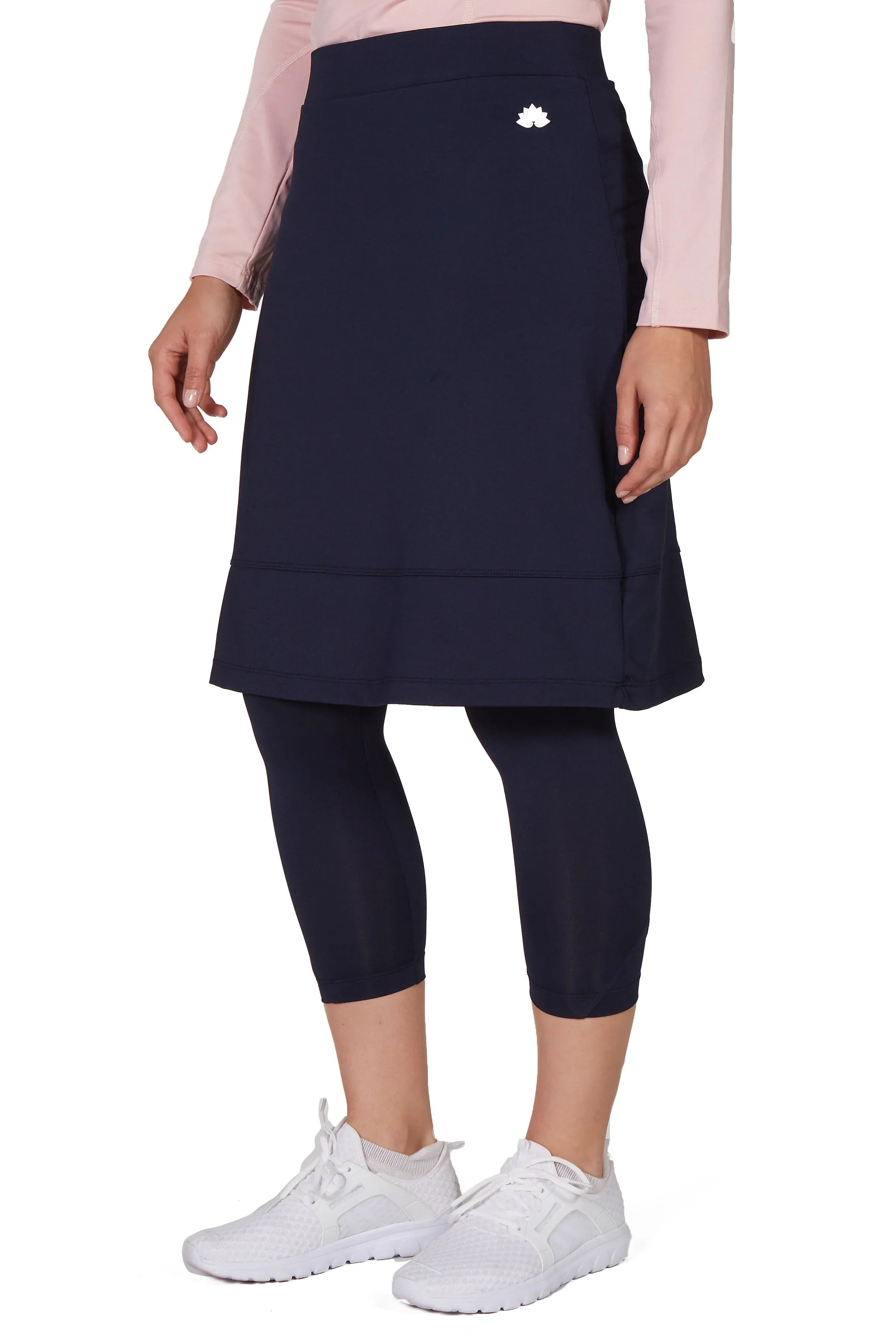 Snoga Athletics navy skirted leggings with a modest fit, worn with white sneakers