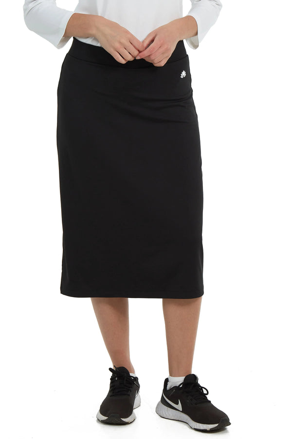 Snoga Athletics black modest activewear skirt with logo, worn with sneakers
