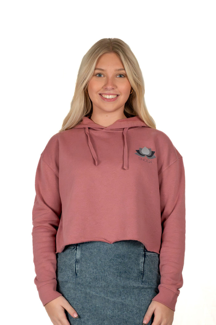 Woman wearing Snoga Athletics cropped mauve hoodie and denim skirt, smiling