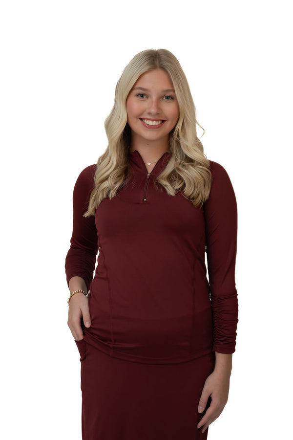 Woman in maroon long sleeve zip-up modest activewear top by Snoga Athletics