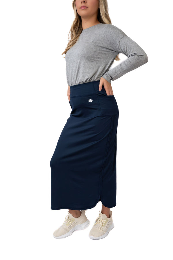 Woman modeling Snoga Athletics modest navy athletic skirt with gray long sleeve top and sneakers