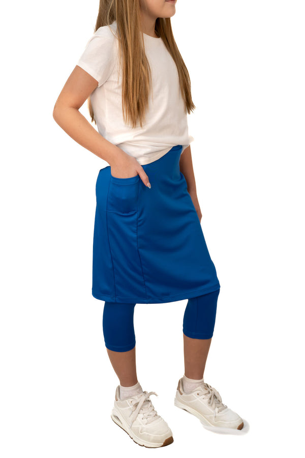 Girl in white shirt and blue Snoga Athletics modest skirt leggings with pockets